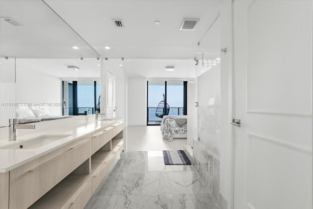 3131 NE 7th Ave Unit 3306, Miami, FL 33137 - ensuite bathroom featuring double vanity, marble look tile flooring, and recessed lighting