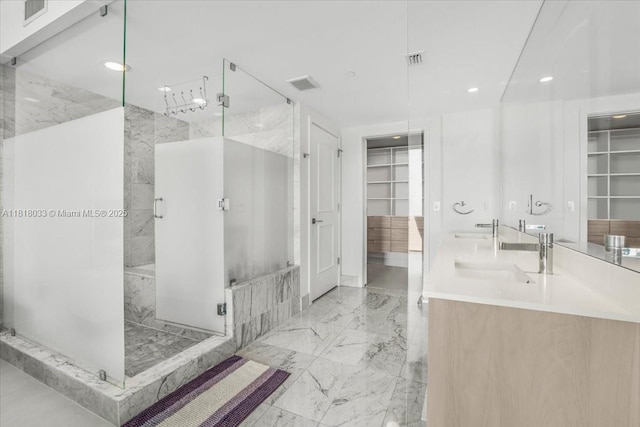3131 NE 7th Ave Unit 3306, Miami, FL 33137 - bathroom with a marble finish shower, marble tiled floors, a spacious closet, double vanity, and recessed lighting