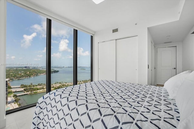 3131 NE 7th Ave Unit 3306, Miami, FL 33137 - bedroom featuring a water view, a closet, and expansive windows