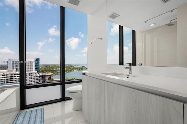 3131 NE 7th Ave Unit 3306, Miami, FL 33137 - bathroom with tile patterned floors, toilet, a city view, vanity, and a shower