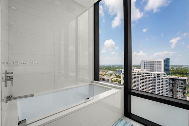 3131 NE 7th Ave Unit 3306, Miami, FL 33137 - full bathroom featuring a view of city, plenty of natural light, and a bath