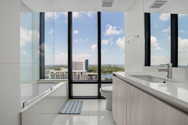 3131 NE 7th Ave Unit 3306, Miami, FL 33137 - bathroom with healthy amount of natural light, toilet, vanity, and tile patterned floors