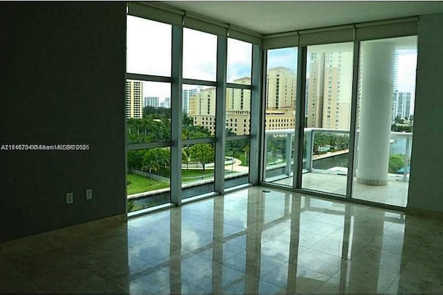3131 NE 188th St Unit 2-906, Aventura, FL 33180 - doorway with floor to ceiling windows, plenty of natural light, a city view, and tile patterned floors