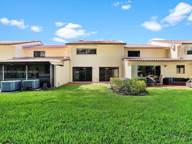 9530 Alcazar Ln, Davie, FL 33324 - back of house featuring central air condition unit, a lawn, and stucco siding