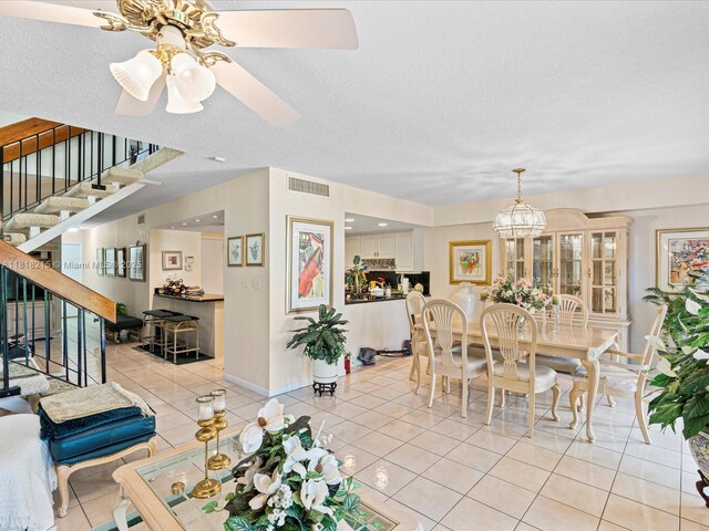 9530 Alcazar Ln, Davie, FL 33324 - dining room with stairway, light tile patterned floors, a textured ceiling, baseboards, and ceiling fan