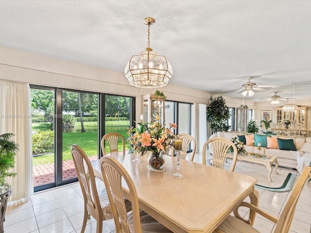 9530 Alcazar Ln, Davie, FL 33324 - dining area with healthy amount of natural light, a chandelier, a textured ceiling, ceiling fan, and light tile patterned floors