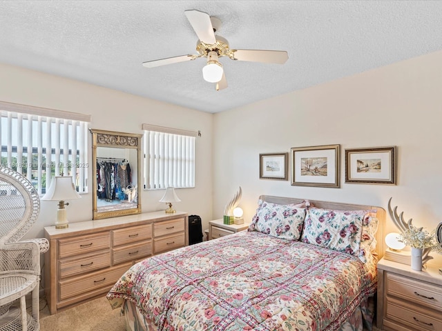 9530 Alcazar Ln, Davie, FL 33324 - bedroom featuring multiple windows, a textured ceiling, light carpet, and ceiling fan