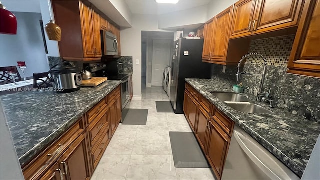 11040 S Lakeview Dr, Pembroke Pines, FL 33026 - kitchen with appliances with stainless steel finishes, tasteful backsplash, dark stone countertops, and brown cabinetry