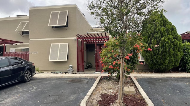 11040 S Lakeview Dr, Pembroke Pines, FL 33026 - multi unit property with stucco siding, uncovered parking, and a pergola