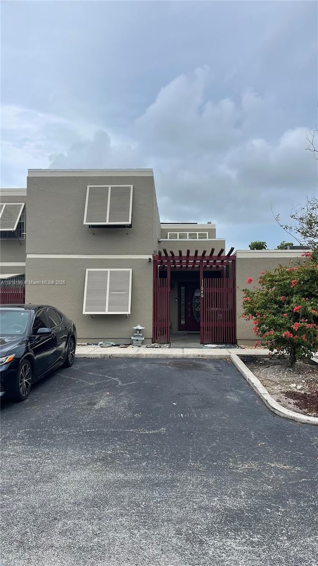 11040 S Lakeview Dr, Pembroke Pines, FL 33026 - view of front facade featuring uncovered parking, a gate, and stucco siding