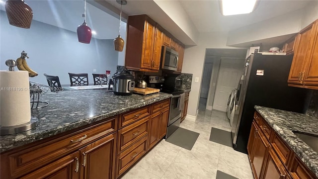 11040 S Lakeview Dr, Pembroke Pines, FL 33026 - kitchen with appliances with stainless steel finishes, dark stone countertops, pendant lighting, brown cabinets, and lofted ceiling