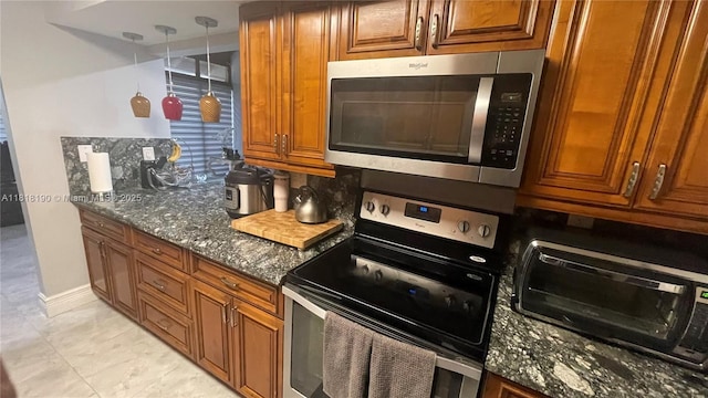 11040 S Lakeview Dr, Pembroke Pines, FL 33026 - kitchen with appliances with stainless steel finishes, dark stone counters, and brown cabinets