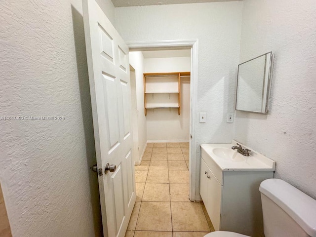 1021 NW 3rd St Unit 206, Miami, FL 33128 - half bath featuring toilet, vanity, tile patterned flooring, and a textured wall