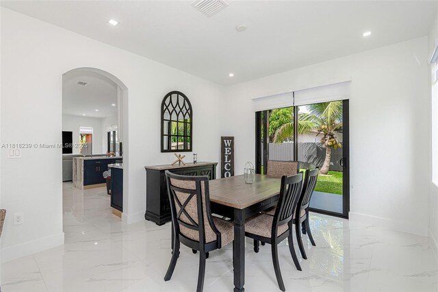 18250 SW 152nd Ave, Miami, FL 33187 - dining room featuring light marble finish floors, recessed lighting, baseboards, and arched walkways