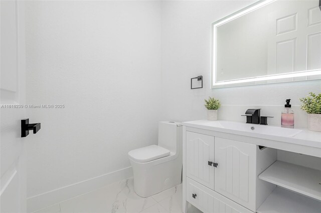 18250 SW 152nd Ave, Miami, FL 33187 - half bathroom with marble finish floors, vanity, toilet, and baseboards