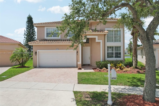 16710 NW 12th St, Pembroke Pines, FL 33028 - mediterranean / spanish house featuring decorative driveway, stucco siding, a garage, a tiled roof, and a front yard