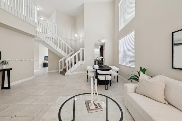 16710 NW 12th St, Pembroke Pines, FL 33028 - living area featuring stairway, a towering ceiling, and tile patterned flooring