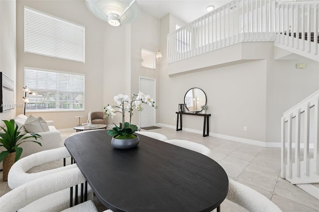 16710 NW 12th St, Pembroke Pines, FL 33028 - dining room featuring a towering ceiling, light tile patterned floors, and stairway