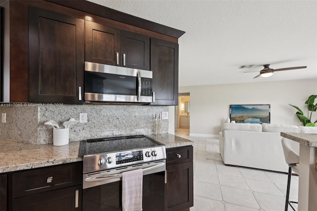 16710 NW 12th St, Pembroke Pines, FL 33028 - kitchen with appliances with stainless steel finishes, dark brown cabinets, ceiling fan, and backsplash