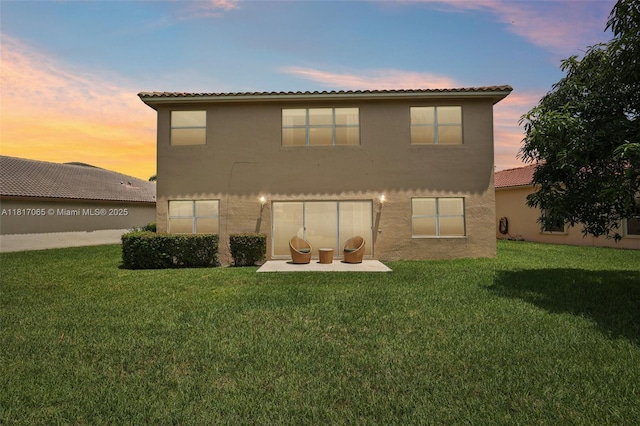 16710 NW 12th St, Pembroke Pines, FL 33028 - rear view of house with stucco siding, a lawn, and a patio area