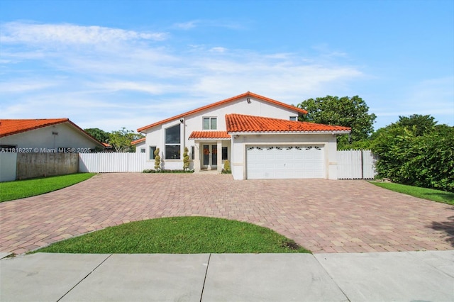 3736 SW 107th Ct, Miami, FL 33165 - mediterranean / spanish home with decorative driveway, a tile roof, an attached garage, and stucco siding