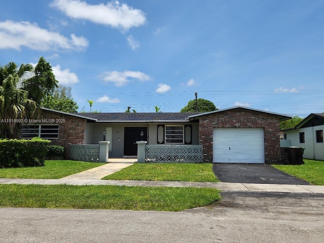 8980 SW 59th St, Miami, FL 33173 - ranch-style home with an attached garage, asphalt driveway, brick siding, and a front lawn