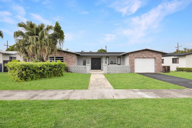 8980 SW 59th St, Miami, FL 33173 - ranch-style house featuring a garage, driveway, brick siding, and a front lawn