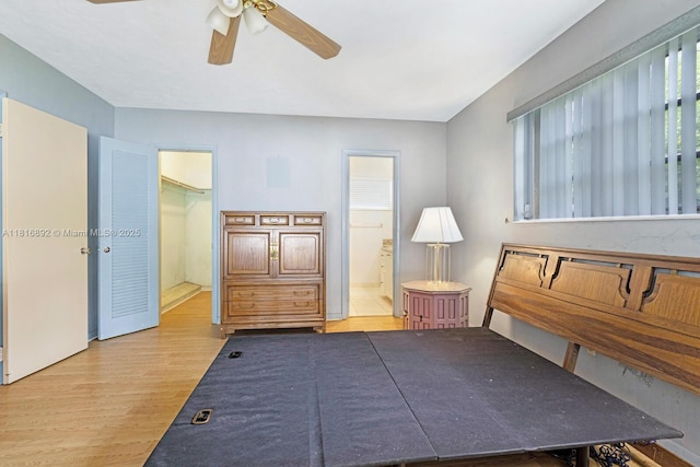 8980 SW 59th St, Miami, FL 33173 - bedroom featuring wood finished floors, connected bathroom, a spacious closet, and a ceiling fan