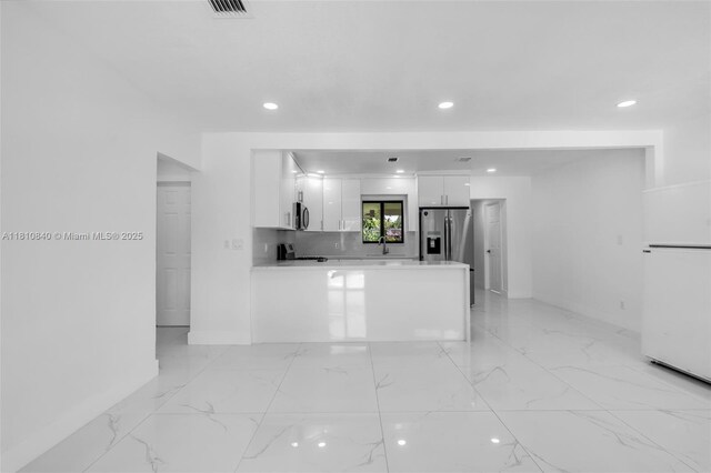 1010 NE 140th St, North Miami, FL 33161 - kitchen with white cabinets, recessed lighting, a sink, stainless steel appliances, and light countertops