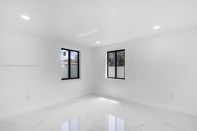 1010 NE 140th St, North Miami, FL 33161 - empty room with baseboards, marble finish flooring, and recessed lighting