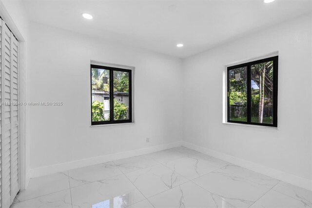 1010 NE 140th St, North Miami, FL 33161 - spare room featuring baseboards, recessed lighting, and marble finish floors