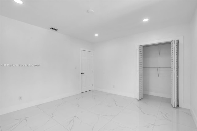 1010 NE 140th St, North Miami, FL 33161 - unfurnished bedroom featuring recessed lighting, marble finish flooring, baseboards, and a closet