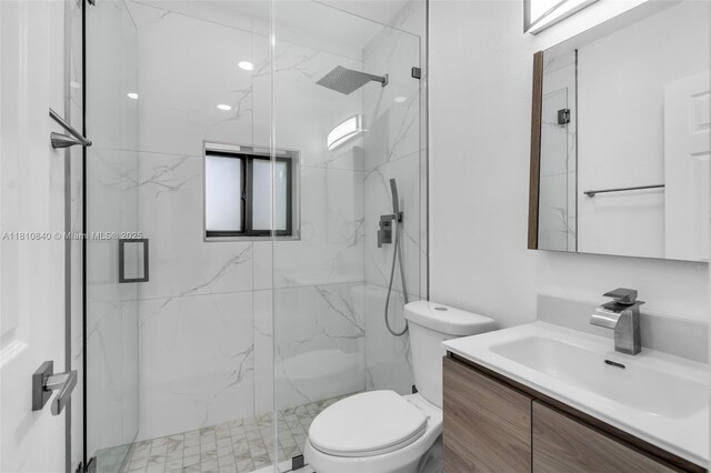 1010 NE 140th St, North Miami, FL 33161 - bathroom with vanity, a marble finish shower, and toilet