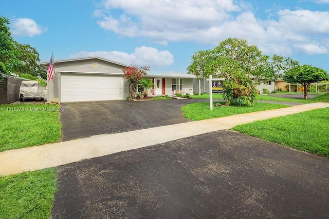 1801 N 55th Ave, Hollywood, FL 33021 - single story home with asphalt driveway, a front yard, and a garage