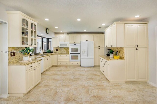 1801 N 55th Ave, Hollywood, FL 33021 - kitchen featuring white appliances, glass insert cabinets, light stone countertops, backsplash, and recessed lighting