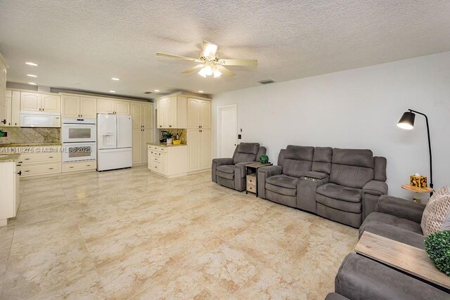 1801 N 55th Ave, Hollywood, FL 33021 - living room featuring a ceiling fan, recessed lighting, and a textured ceiling