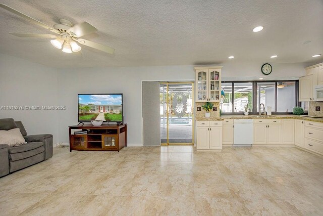 1801 N 55th Ave, Hollywood, FL 33021 - kitchen with white appliances, open floor plan, glass insert cabinets, light stone countertops, and recessed lighting