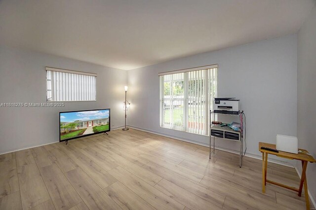 1801 N 55th Ave, Hollywood, FL 33021 - unfurnished living room with light wood finished floors and baseboards