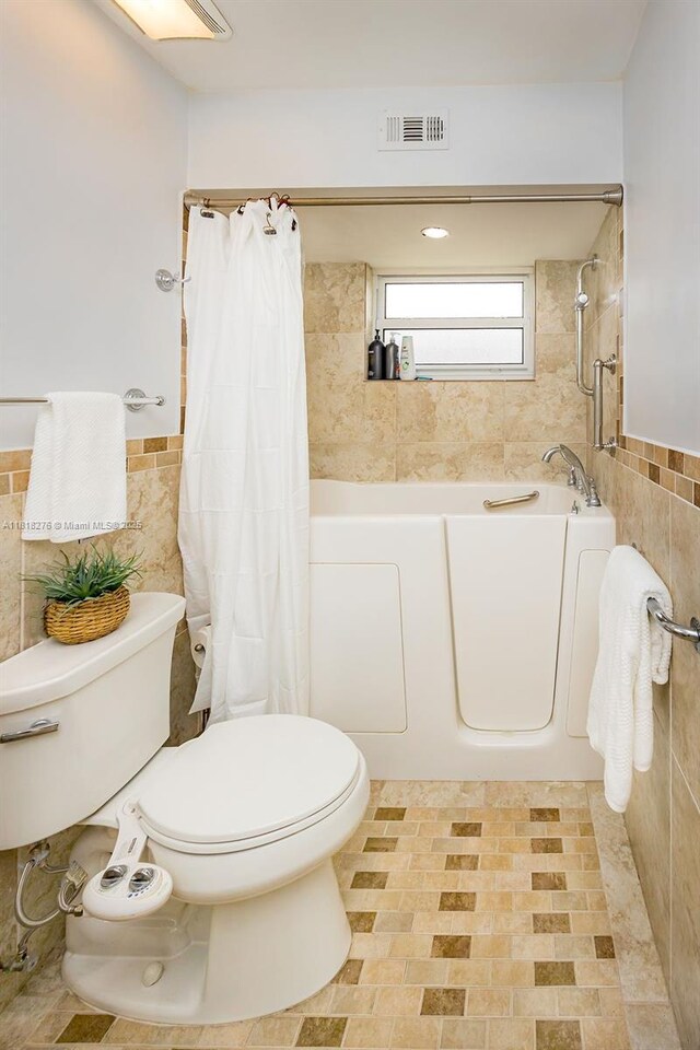 1801 N 55th Ave, Hollywood, FL 33021 - full bath featuring tile walls, toilet, a bathtub, a shower with curtain, and wainscoting