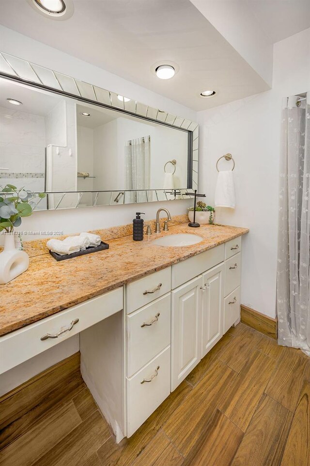 1801 N 55th Ave, Hollywood, FL 33021 - bathroom featuring vanity, wood finished floors, and baseboards