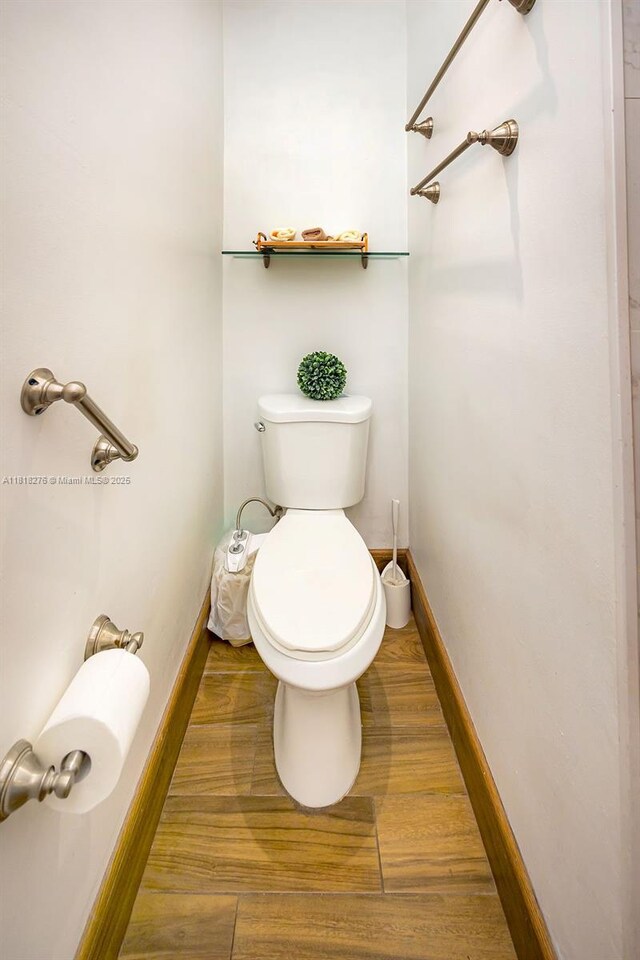 1801 N 55th Ave, Hollywood, FL 33021 - bathroom with toilet, wood finished floors, and baseboards