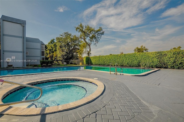 8350 Sands Point Blvd Unit E309, Tamarac, FL 33321 - community pool featuring a hot tub and a patio