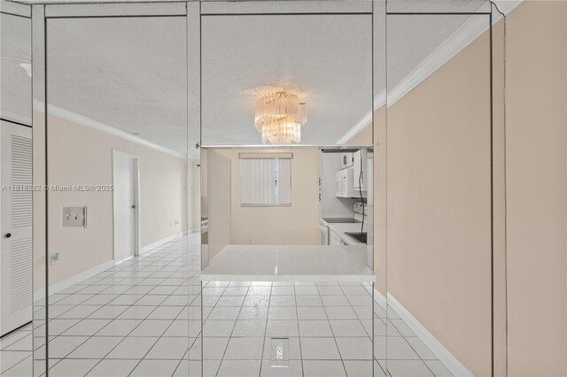 8350 Sands Point Blvd Unit E309, Tamarac, FL 33321 - corridor featuring crown molding, a chandelier, and light tile patterned floors