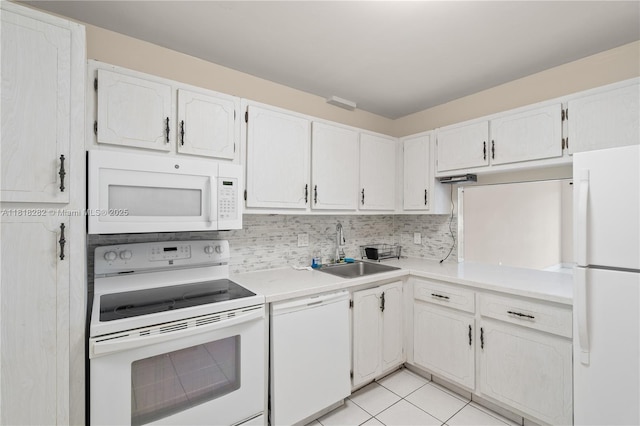 8350 Sands Point Blvd Unit E309, Tamarac, FL 33321 - kitchen featuring white appliances, light countertops, backsplash, light tile patterned floors, and white cabinetry