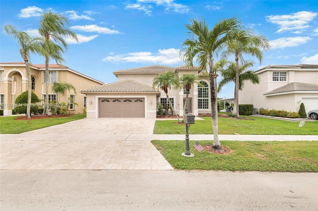 2256 SW 183rd Ter, Miramar, FL 33029 - mediterranean / spanish-style house featuring driveway, an attached garage, a front lawn, stucco siding, and a tiled roof