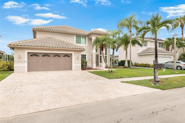 2256 SW 183rd Ter, Miramar, FL 33029 - mediterranean / spanish-style house with stucco siding, a front yard, driveway, a garage, and a tiled roof