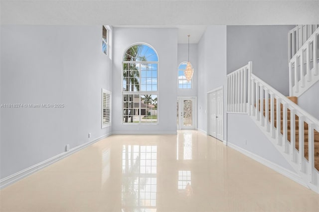 2256 SW 183rd Ter, Miramar, FL 33029 - foyer with a towering ceiling, stairway, tile patterned floors, and baseboards