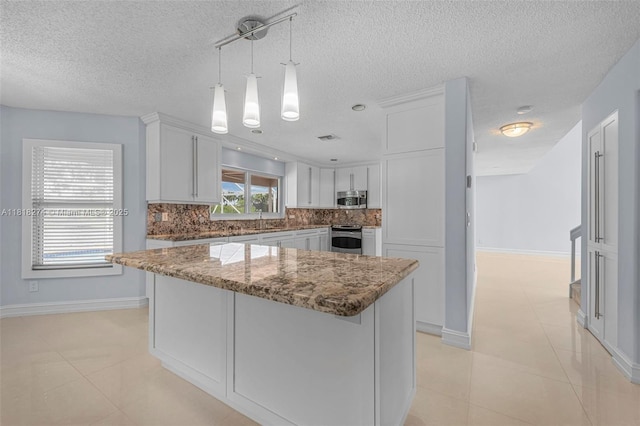 2256 SW 183rd Ter, Miramar, FL 33029 - kitchen with stainless steel appliances, decorative backsplash, white cabinetry, a sink, and stone counters