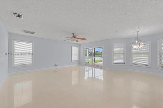 2256 SW 183rd Ter, Miramar, FL 33029 - spare room featuring light tile patterned floors, a textured ceiling, a ceiling fan, and baseboards