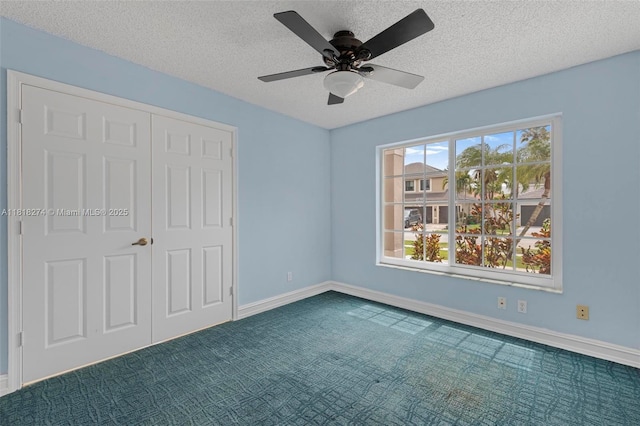 2256 SW 183rd Ter, Miramar, FL 33029 - unfurnished bedroom featuring dark colored carpet, a textured ceiling, baseboards, a closet, and a ceiling fan